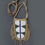 A CHEYENNE BEADED AND FRINGED HIDE BELT POUCH