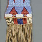 A CROW BEADED AND FRINGED HIDE TOBACCO BAG